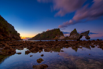 beautiful sunrise scenery of unique rock island at atuh beach nusa penida, bali