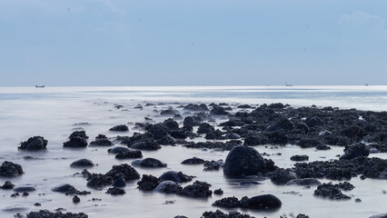 Waves crashing against rocks - water flowing over rocks