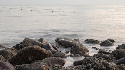 Waves crashing against rocks - water flowing over rocks