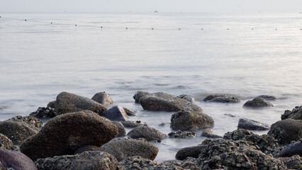 Waves crashing against rocks - water flowing over rocks