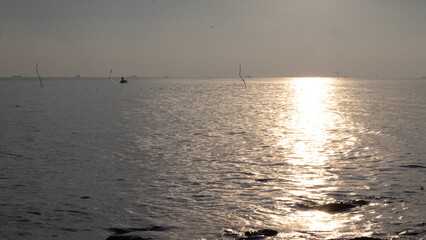 sunrise on the beach. beautiful summer scenery. calm waves on the water. clouds on the sky. wide panoramic view