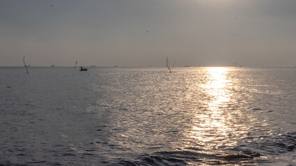 sunrise on the beach. beautiful summer scenery. calm waves on the water. clouds on the sky. wide panoramic view