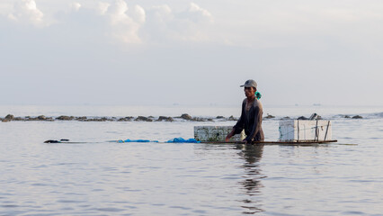 Fototapeta na wymiar Shrimp fisherman carrying catch with Styrofoam