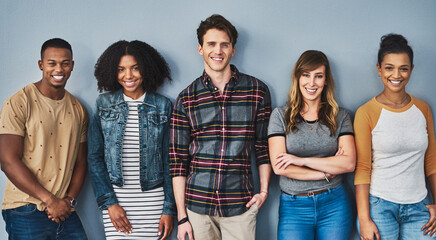 Good friends stand together. Studio portrait of a diverse group of young people standing together against a gray background. - Powered by Adobe
