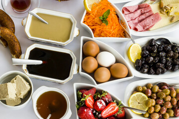 Traditional Turkish Spread Breakfast with boiled eggs,fresh fruits and vegetables.Top view