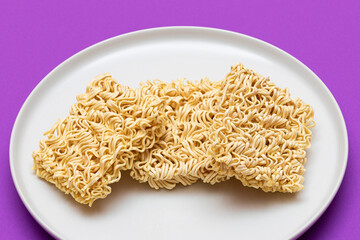 Uncooked Instant Noodles on White Plate. Raw Pasta. Dry Asian Fast Food. Quick Lunch