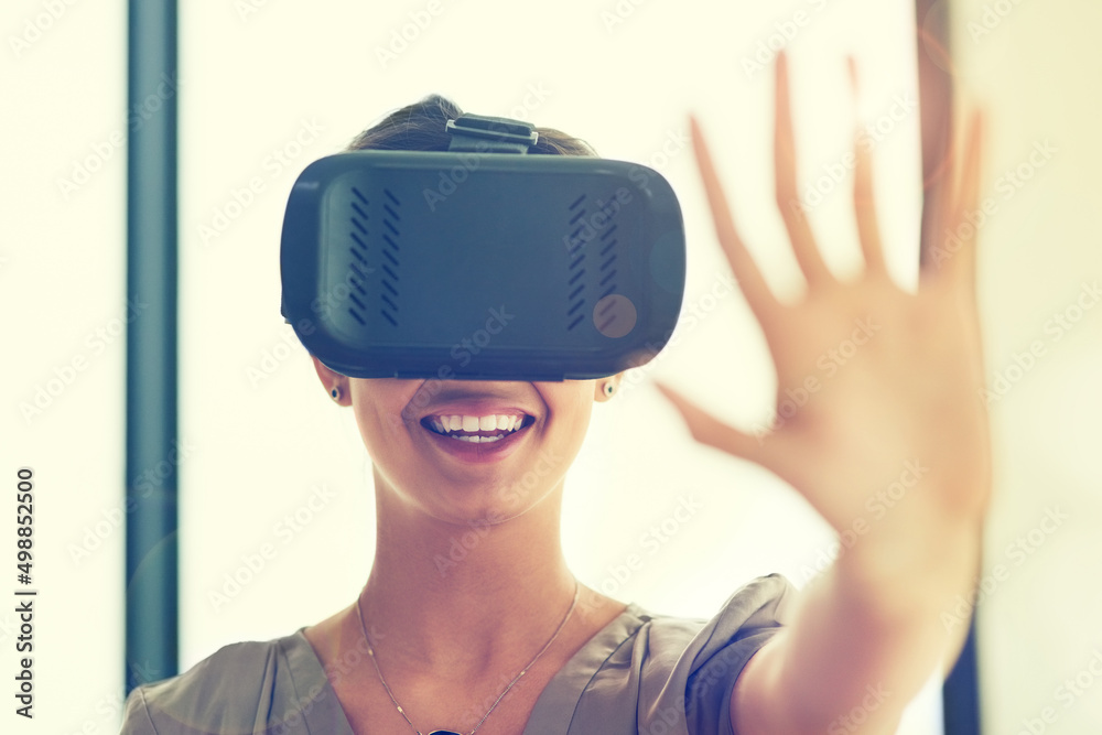 Poster reaching out to a whole new world of opporunity. shot of a young businesswoman wearing a vr headset 