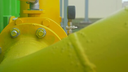 Structural bolt with hex nut and washer connect yellow pipes. Factory distribution and industrial processing of natural gas.  - Powered by Adobe