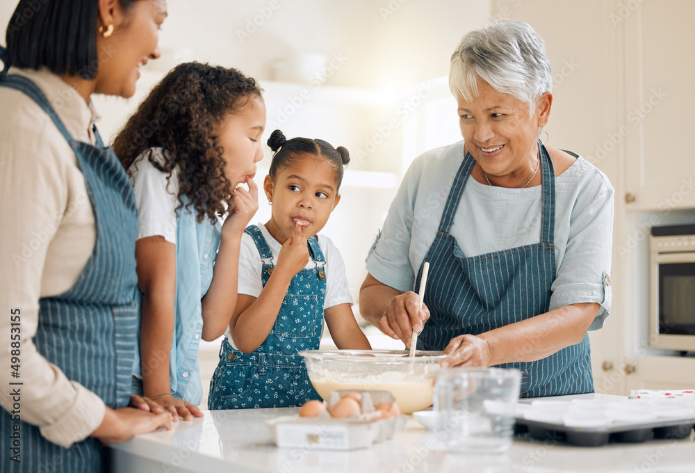 Wall mural Your mom likes to like the bowl when she was your age. Shot of a multi-generational family baking together at home.