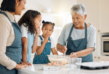 Your mom likes to like the bowl when she was your age. Shot of a multi-generational family baking...