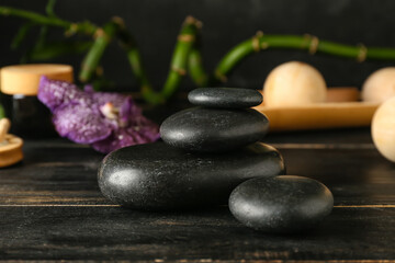 Spa stones on dark wooden background