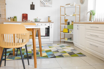 Dining table with chairs in modern interior of kitchen