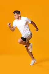 Obraz na płótnie Canvas Sporty male runner on color background