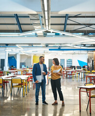 Obraz premium Id like to run some of these ideas by you.... Shot of two young designers having a discussion in an office.
