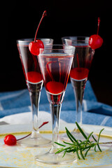 cherry liqueur and vodka cocktail with berry on wooden table. tasty sweet shot.