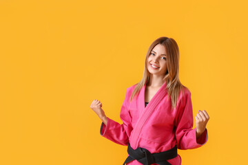 Happy female karate instructor on color background © Pixel-Shot
