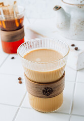 Ground drip coffee using paper type filter with coffee beans on white ceramic tiles background
