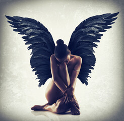 Fototapety  Poise in the stillness. Shot of of naked woman with wings spreading out behind her back.