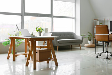 Comfortable workplace in light office interior