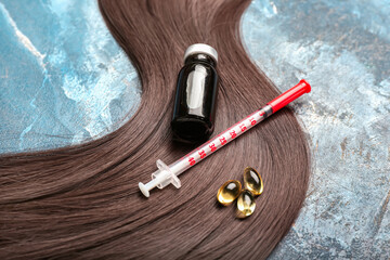 Brunette hair with syringe, medical bottle and pills on grunge background