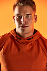 Fototapeta premium Living a healthy lifestyle makes me confident. Studio portrait of a handsome young male athlete posing against an orange background.