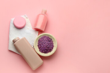 Cosmetic products, bowl of sea salt and clean towel on pink background