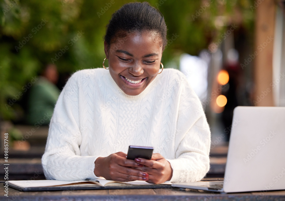 Poster all the apps a student could want. shot of a young woman using a smartphone while studying in a cafe