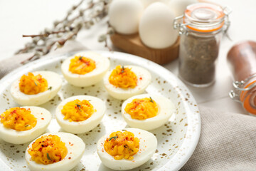 Plate with stuffed eggs on napkin, closeup. Easter celebration