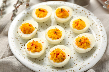 Plate with tasty stuffed eggs on napkin. Easter celebration