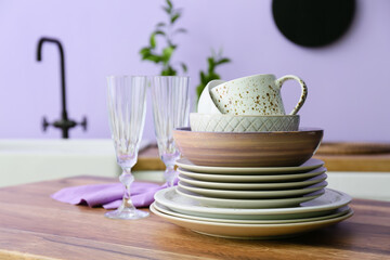 Set of clean tableware in kitchen