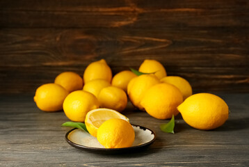 Ripe fresh yellow lemons on table