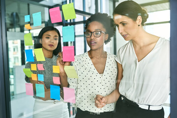 Coming up with a plan for success. Cropped shot of three businesswoman strategising in their office.