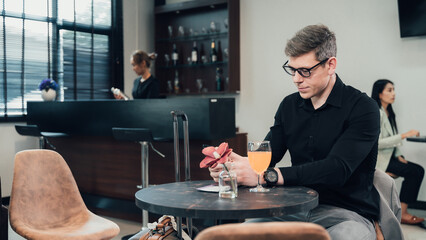 Young businessman waiting for his flight in the lobby area.