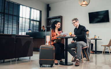 Diverse business partners sitting in modern airport lounge with