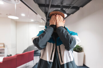 young male cover his face with hand, shame and disappointment concept, facepalm emotion