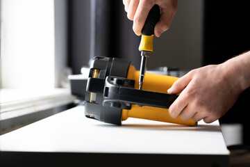 worker hand holding a manual screwdriver tool. professional occupation work screw