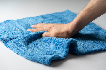 hand holding microfiber rag and wipe surface, home cleaning