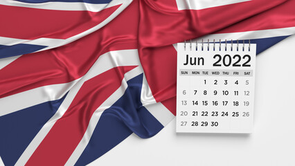 White-colored June calendar page and English flag. Horizontal composition with copy space. Isolated with clipping path.