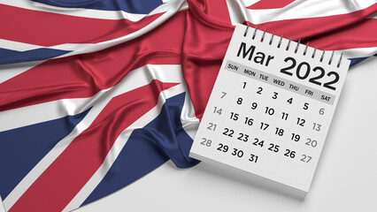 White-colored March-month calendar page and English flag. Horizontal composition with copy space. Isolated with clipping path.