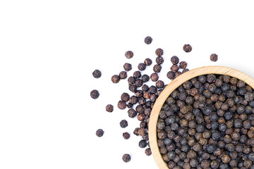 Black pepper in wooden bowl on white background