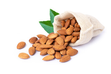 Almond nuts in hemp sack bag with green leaves isolated on white background.