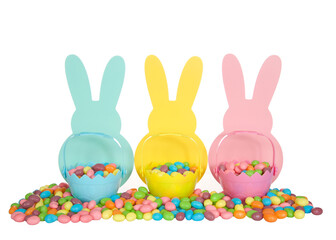 Three colorful wooden Easter Bunny Silhouettes in blue, yellow and pink with matching colored tiny easter baskets full of candy jelly beans sitting on colorful jelly beans, isolated on white.