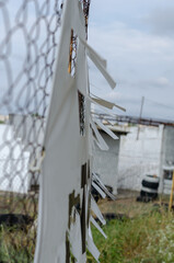 The banner is attached to the Rabitz grid. White banner with perforated wind holes. Special holes...