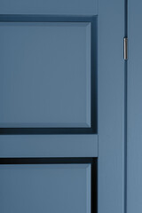 Fragment of new stylish painted wooden blue door