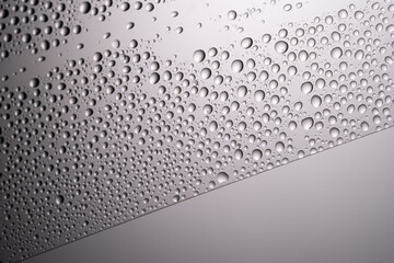 Drops of water on a transparent gray background.