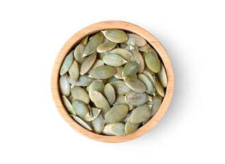 Pumpkin seeds in wooden bowl isolated on wooden table background. Top view. Flat lay.