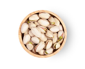 Pistachio nuts in wooden bowl isolated on white background. Top view. Flat lay.