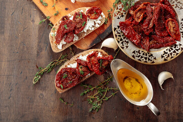 Bruschetta with ricotta, sun-dried tomatoes, and thyme.