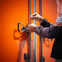 Delivery Man Using A Door Lock Security Seal. Safety Protect Cargo Transport. Shipping Cargo...