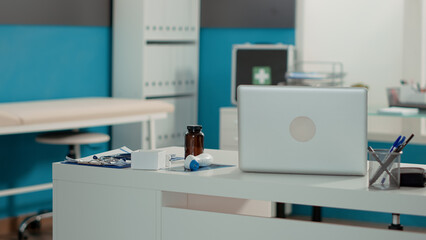 No people in medical cabinet with empty desk and instruments, used for consultation appointment. Nobody in clinical office with professional equipment and technology for checkup visit.